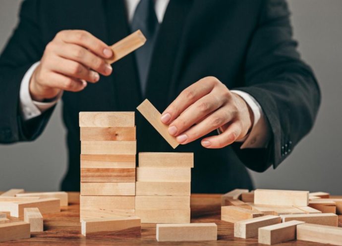 man-wooden-cubes-table-management-concept (1)